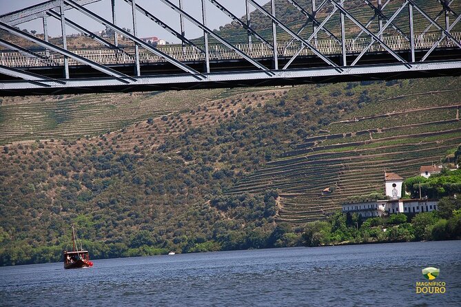 1-Hour Rabelo Boat Trip in Pinhão - Leaving Pinhão beneath the Eiffel iron bridge
