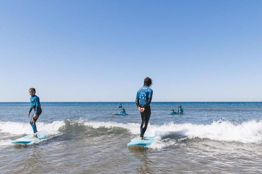 Matosinhos: Best surf Lesson with all equipment - Getting into the Atlantic
