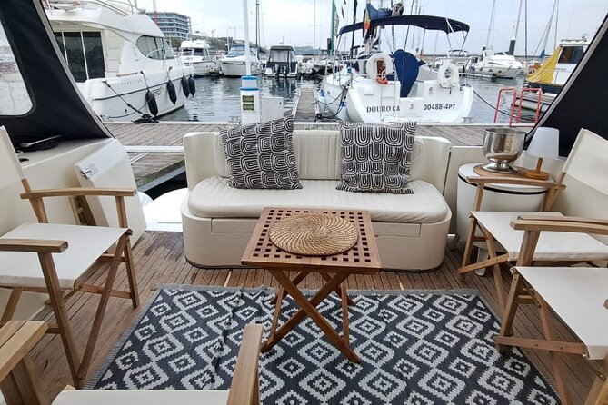 PORTO : Premium Yacht Tour – 6 Bridges & Douro Estuary Reserve - A small yacht with several places to sit